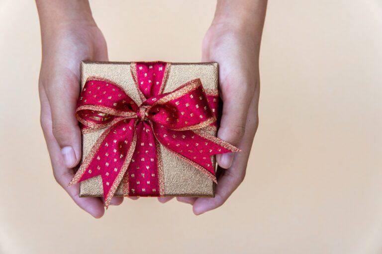 gollden gift box with red ribbow , giving gift box for special person on special day