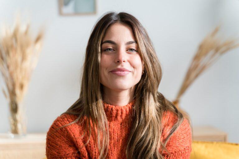 Young smiling woman at living room