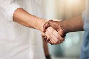 Business, handshake and partnership for deal, agreement or commitment in collaboration at the offic