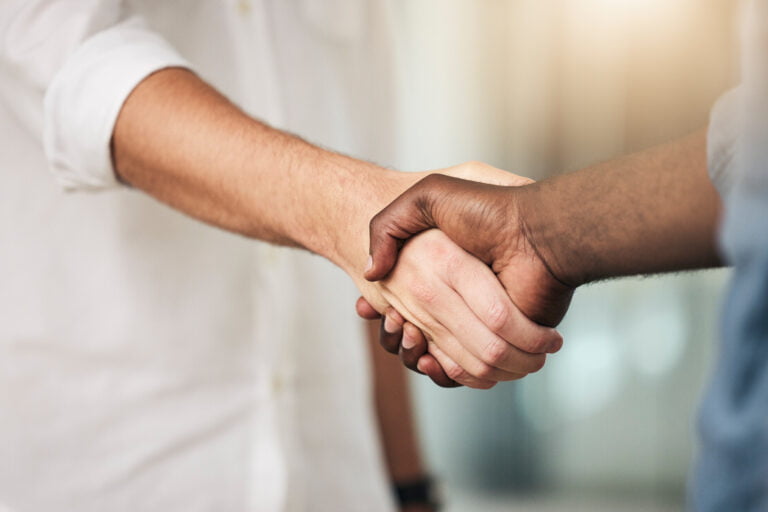 Business, handshake and partnership for deal, agreement or commitment in collaboration at the offic