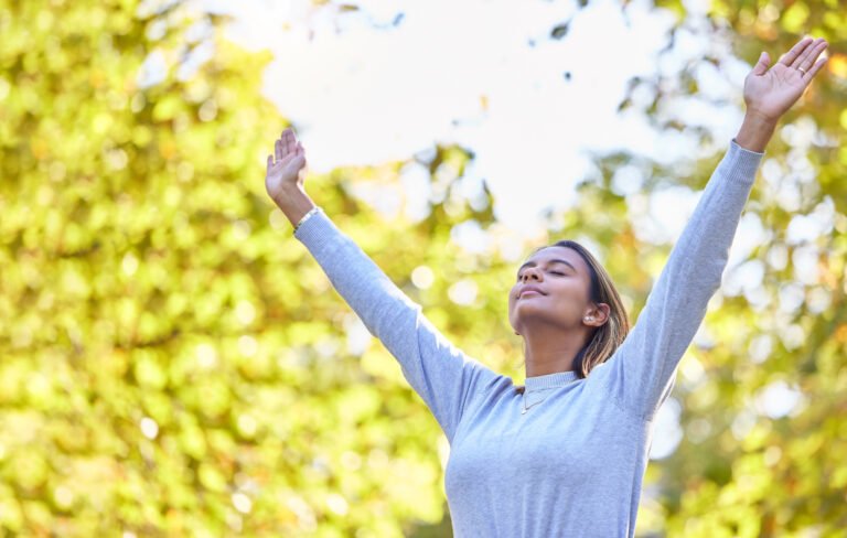 Woman, park and hands open in air for nature, gratitude and self care with mindfulness in sunshine.
