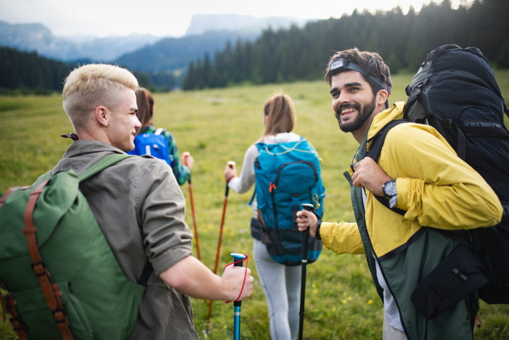 Hiking with friends is so fun. Group of young people with backpacks walking together