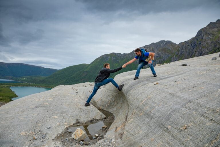 Man helping son in mountain