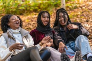 Multi-ethnic friends laughing sitting on a park