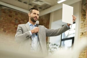 Happy speaker demonstrating something on the paper
